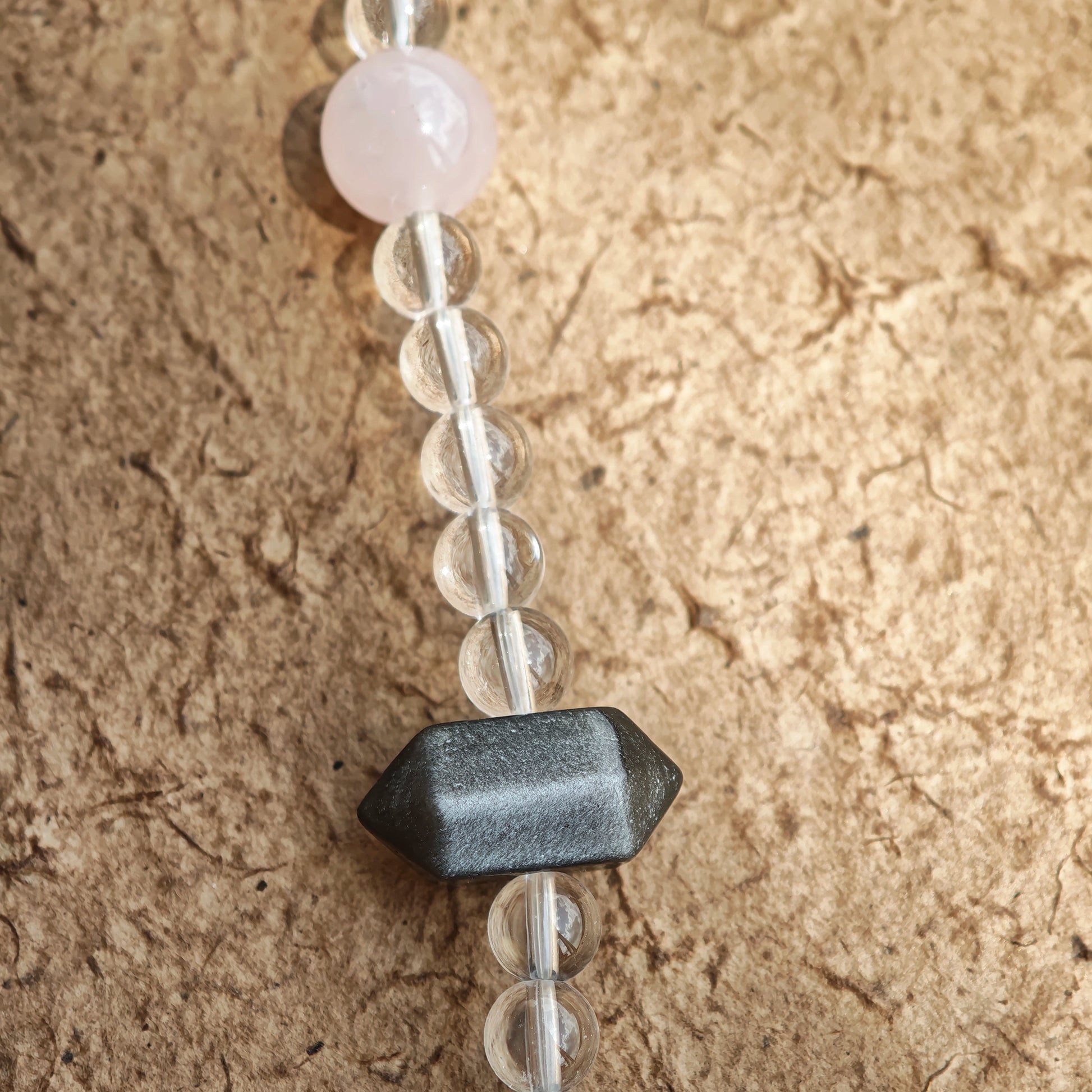 A multi-gemstone bracelet which is made with Silver Sheen Obsidian, Clear Quartz, Amethyst, Rose Quartz, Kyanite, Citrine, and Prehnite, etc. It’s also a necklace.