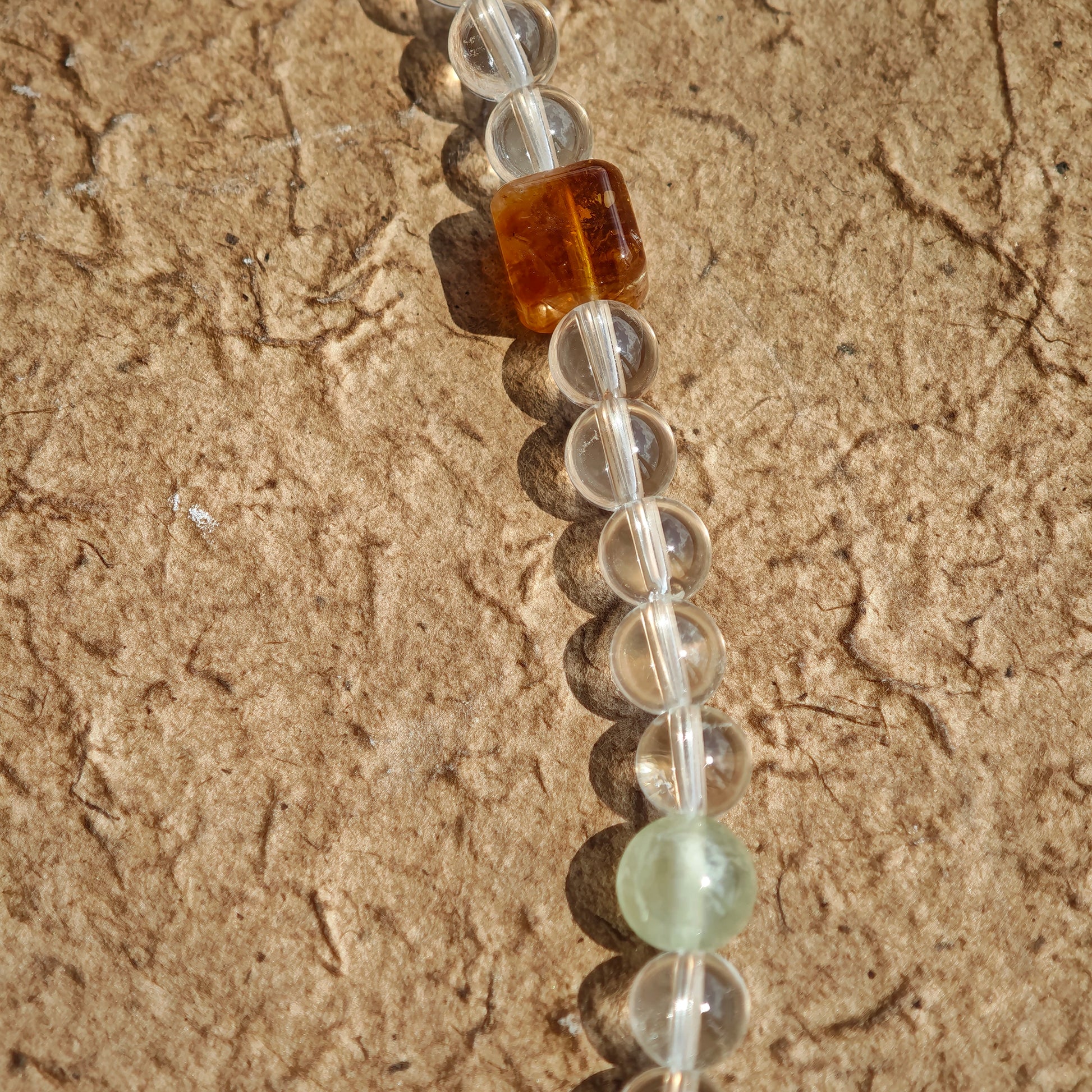 A multi-gemstone bracelet which is made with Silver Sheen Obsidian, Clear Quartz, Amethyst, Rose Quartz, Kyanite, Citrine, and Prehnite, etc. It’s also a necklace.