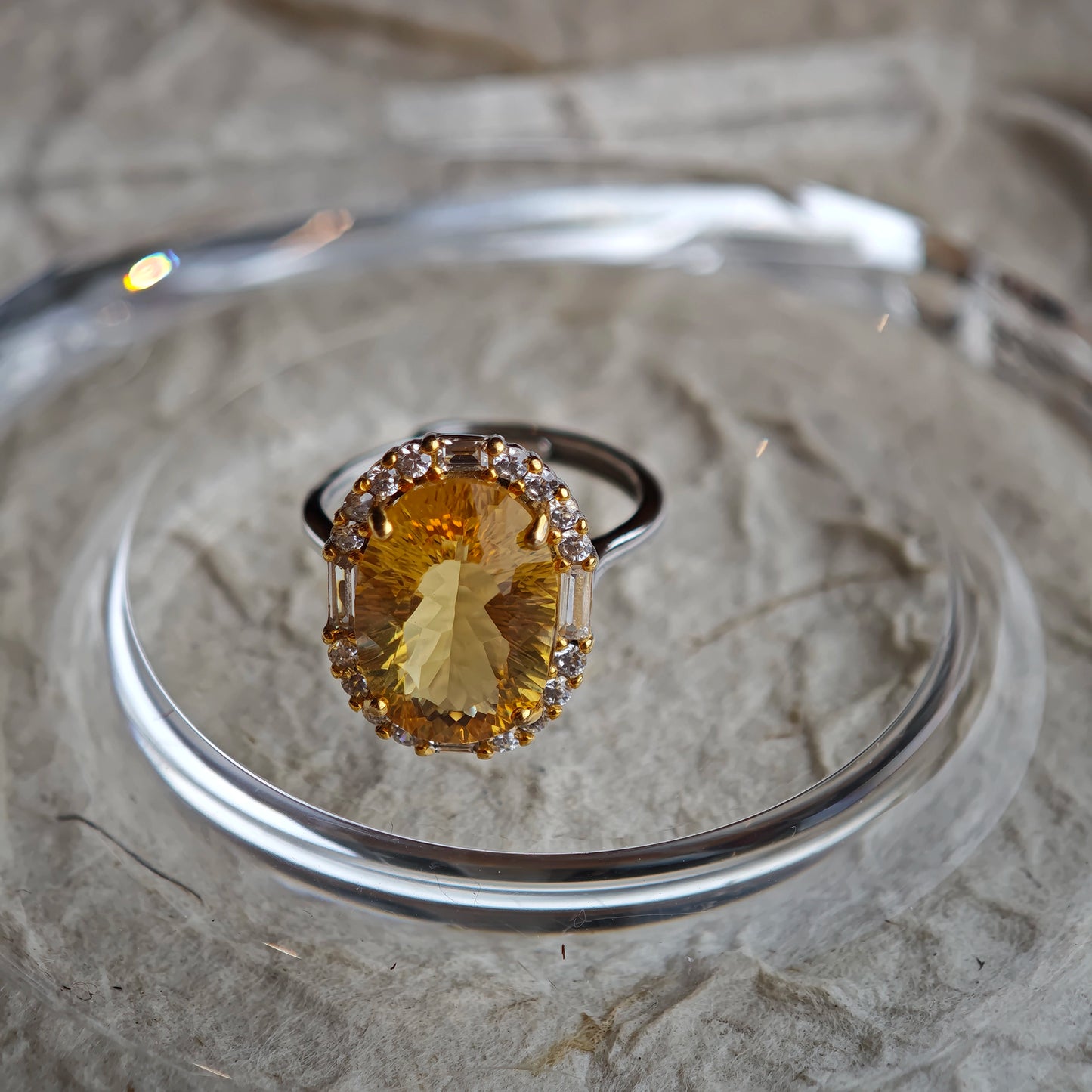 The stone’s 128-facet crown drinks in daylight and pours it back out in liquid gold flashes.