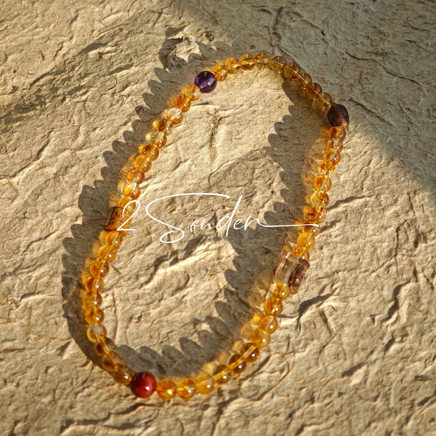 This is a layered bracelet consists of citrine beads, amethyst and aloeswood beads.