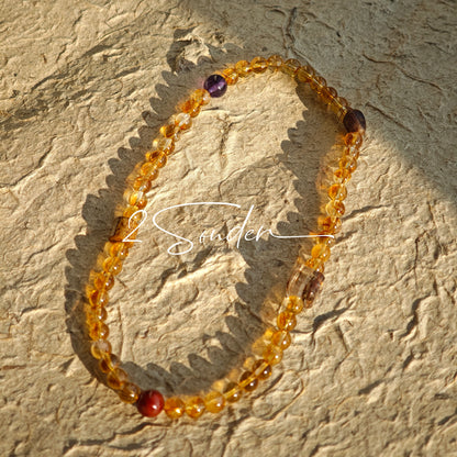 This is a layered bracelet consists of citrine beads, amethyst and aloeswood beads.