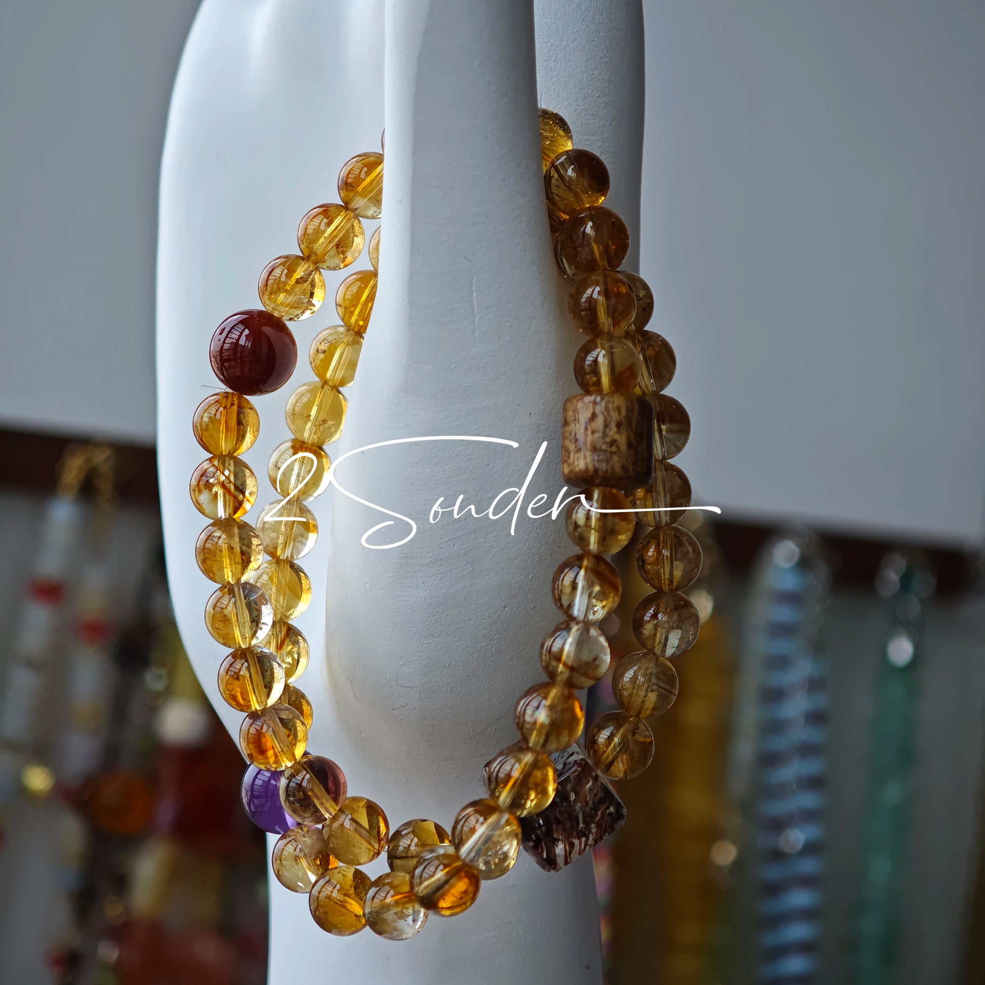 This is a layered bracelet consists of citrine beads, amethyst and aloeswood beads.