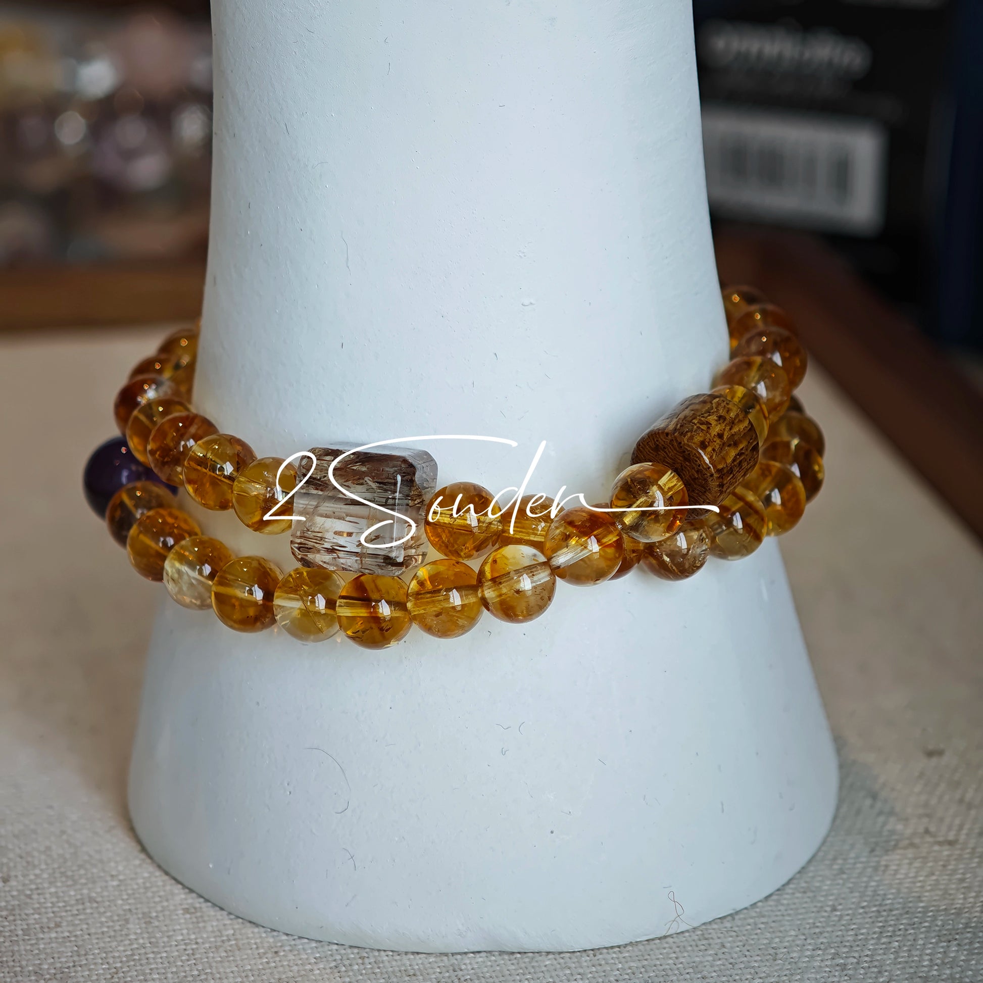 This is a layered bracelet consists of citrine beads, amethyst and aloeswood beads.