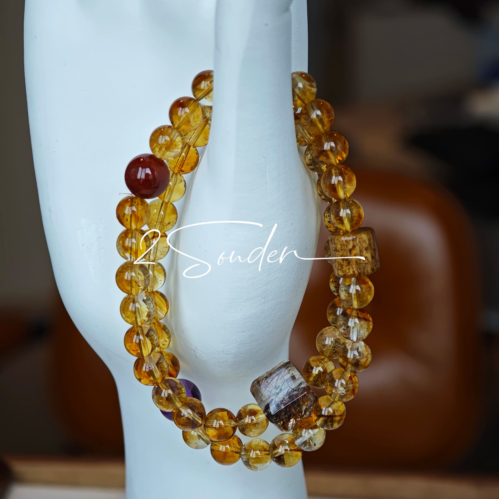 This is a layered bracelet consists of citrine beads, amethyst and aloeswood beads.
