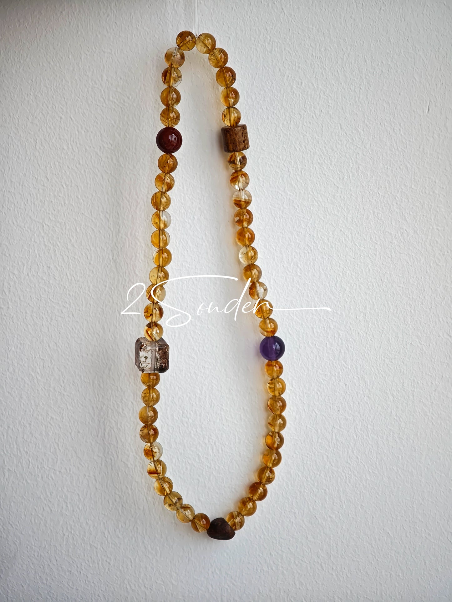 This is a layered bracelet consists of citrine beads, amethyst and aloeswood beads.