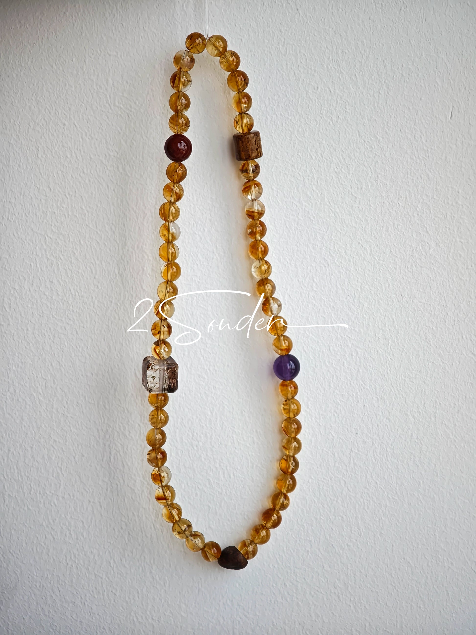 This is a layered bracelet consists of citrine beads, amethyst and aloeswood beads.