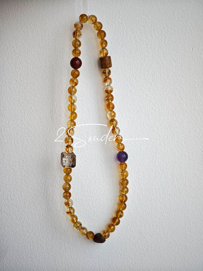 This is a layered bracelet consists of citrine beads, amethyst and aloeswood beads.