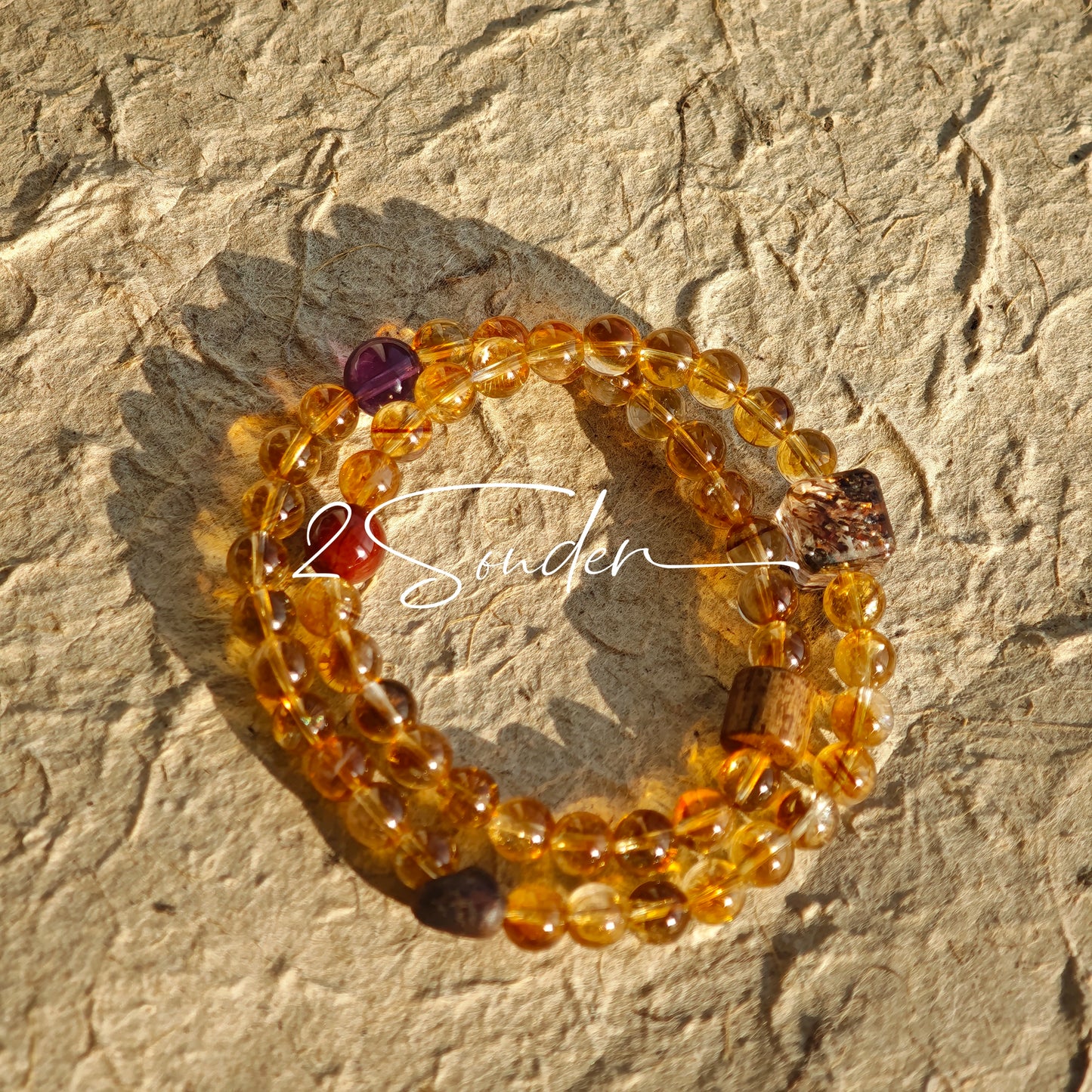 This is a layered bracelet consists of citrine beads, amethyst and aloeswood beads.