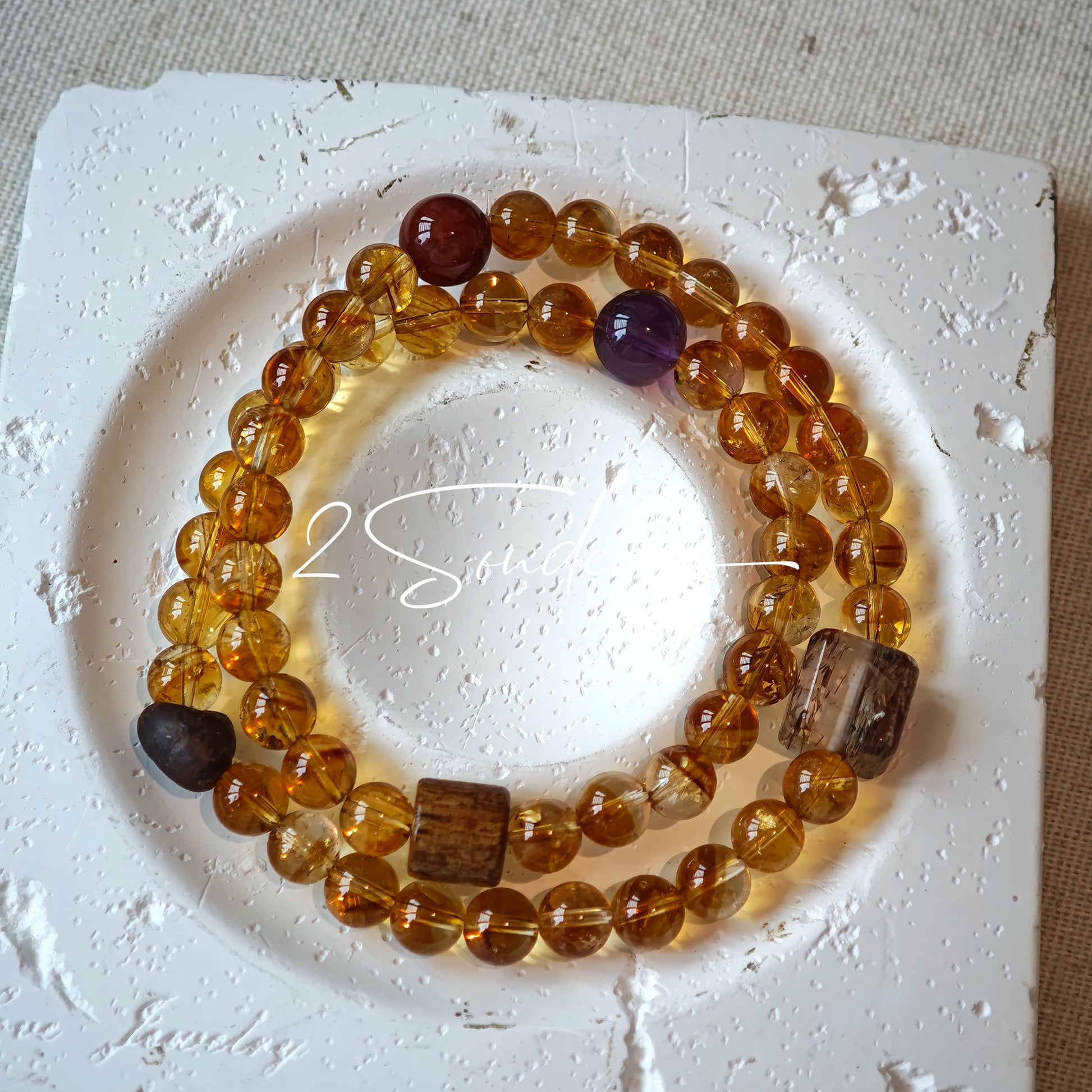 This is a layered bracelet consists of citrine beads, amethyst and aloeswood beads.