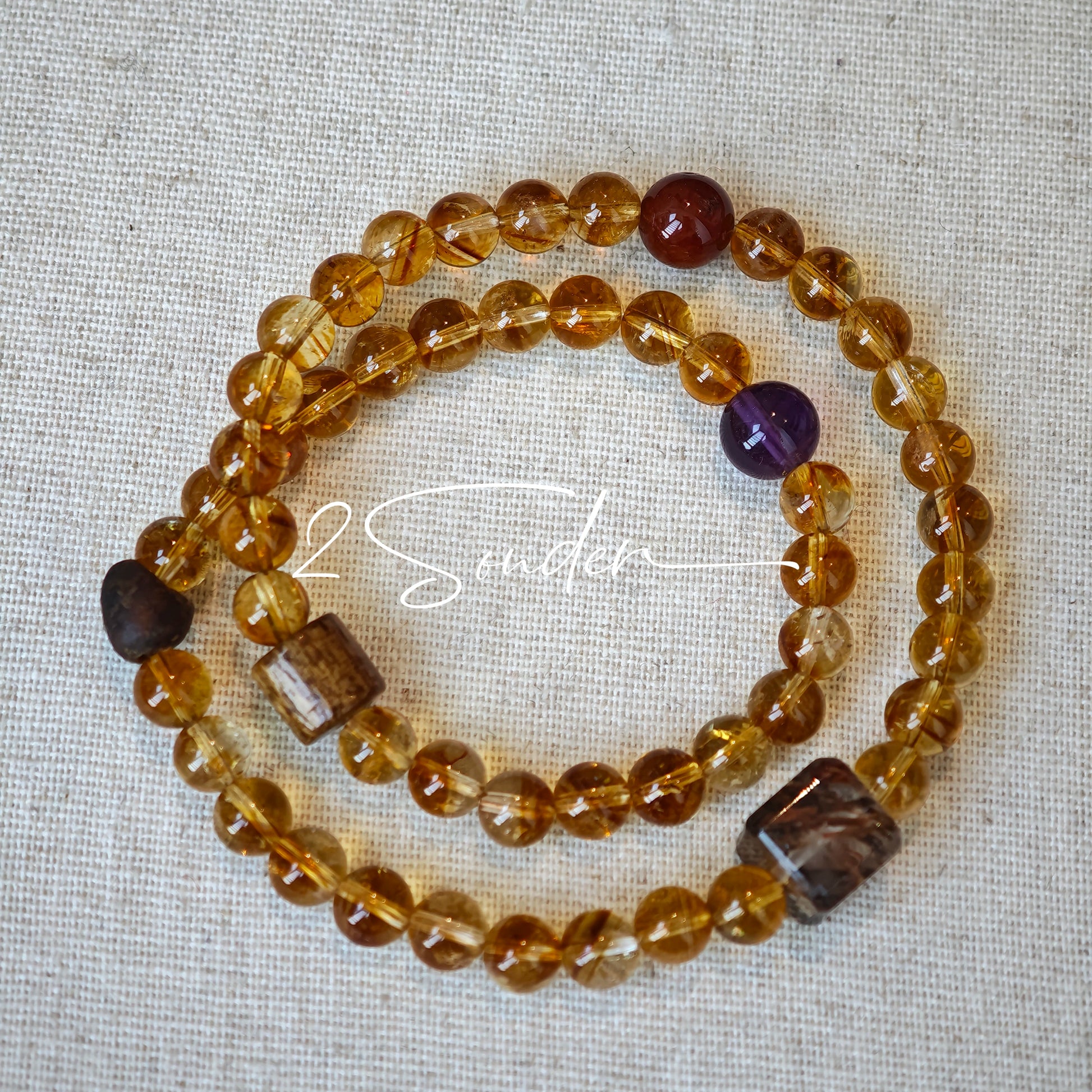 This is a layered bracelet consists of citrine beads, amethyst and aloeswood beads.