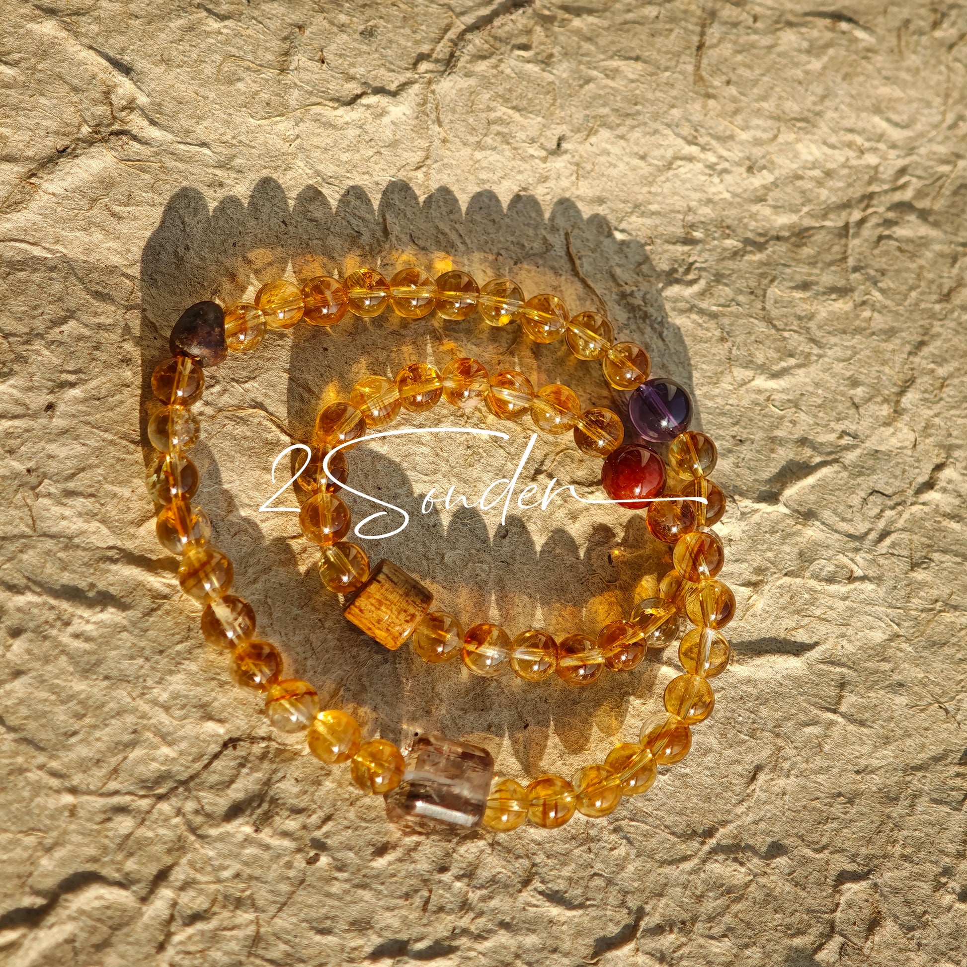This is a layered bracelet consists of citrine beads, amethyst and aloeswood beads.