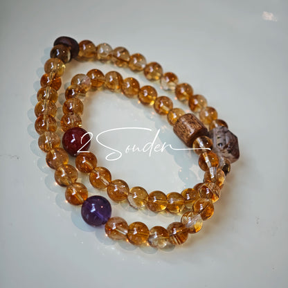 This is a layered bracelet consists of citrine beads, amethyst and aloeswood beads.