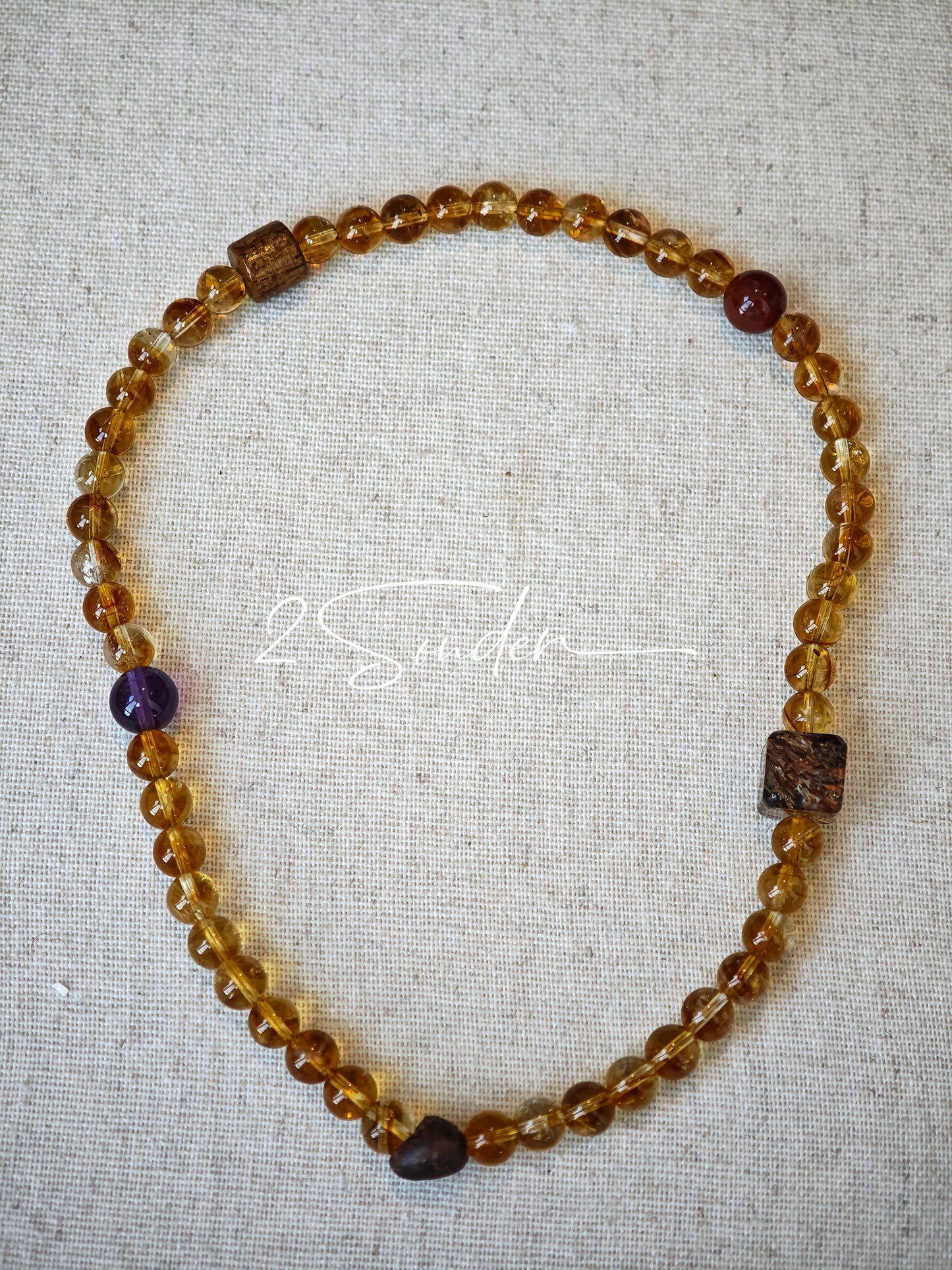 This is a layered bracelet consists of citrine beads, amethyst and aloeswood beads.