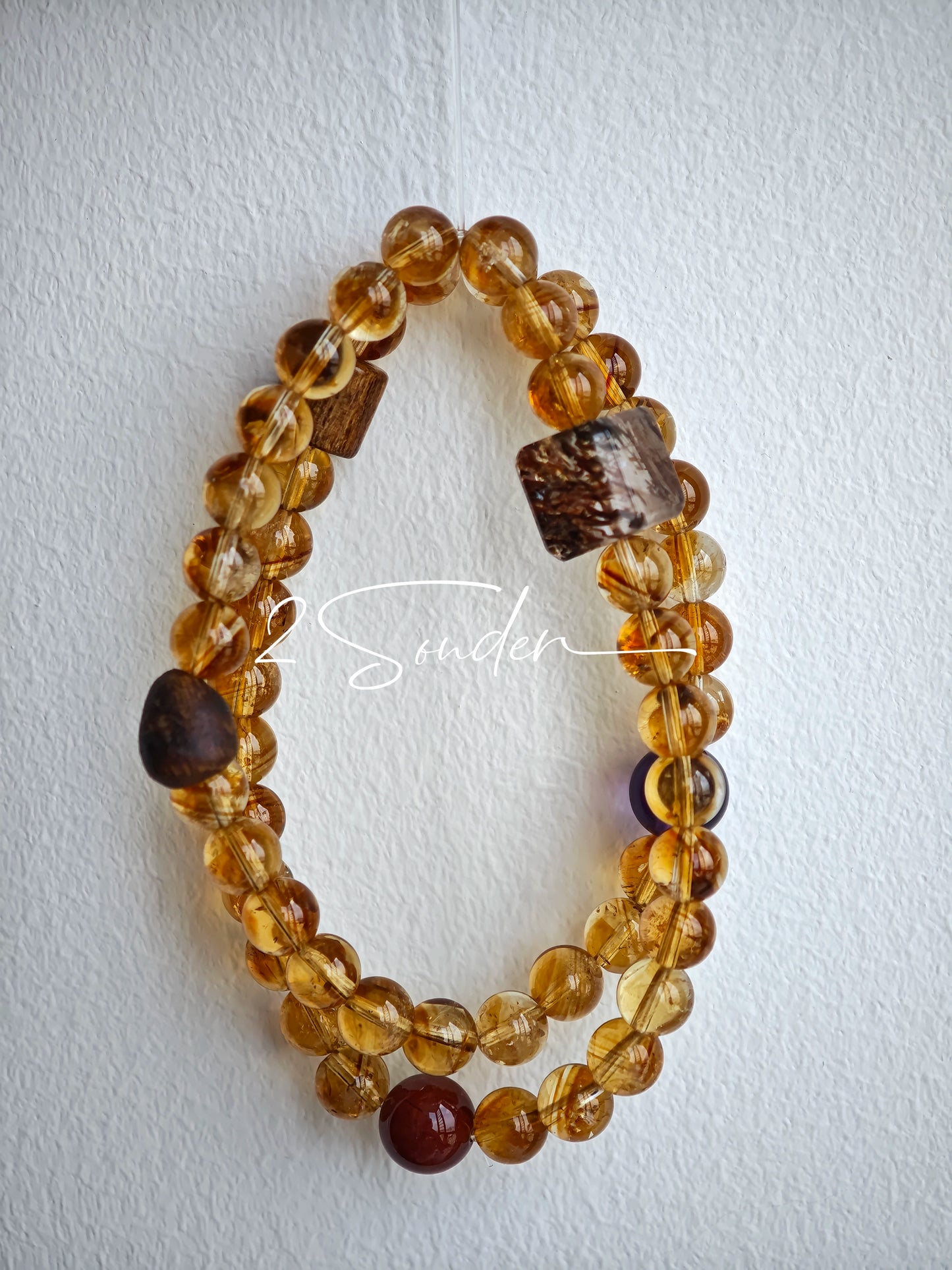 This is a layered bracelet consists of citrine beads, amethyst and aloeswood beads.