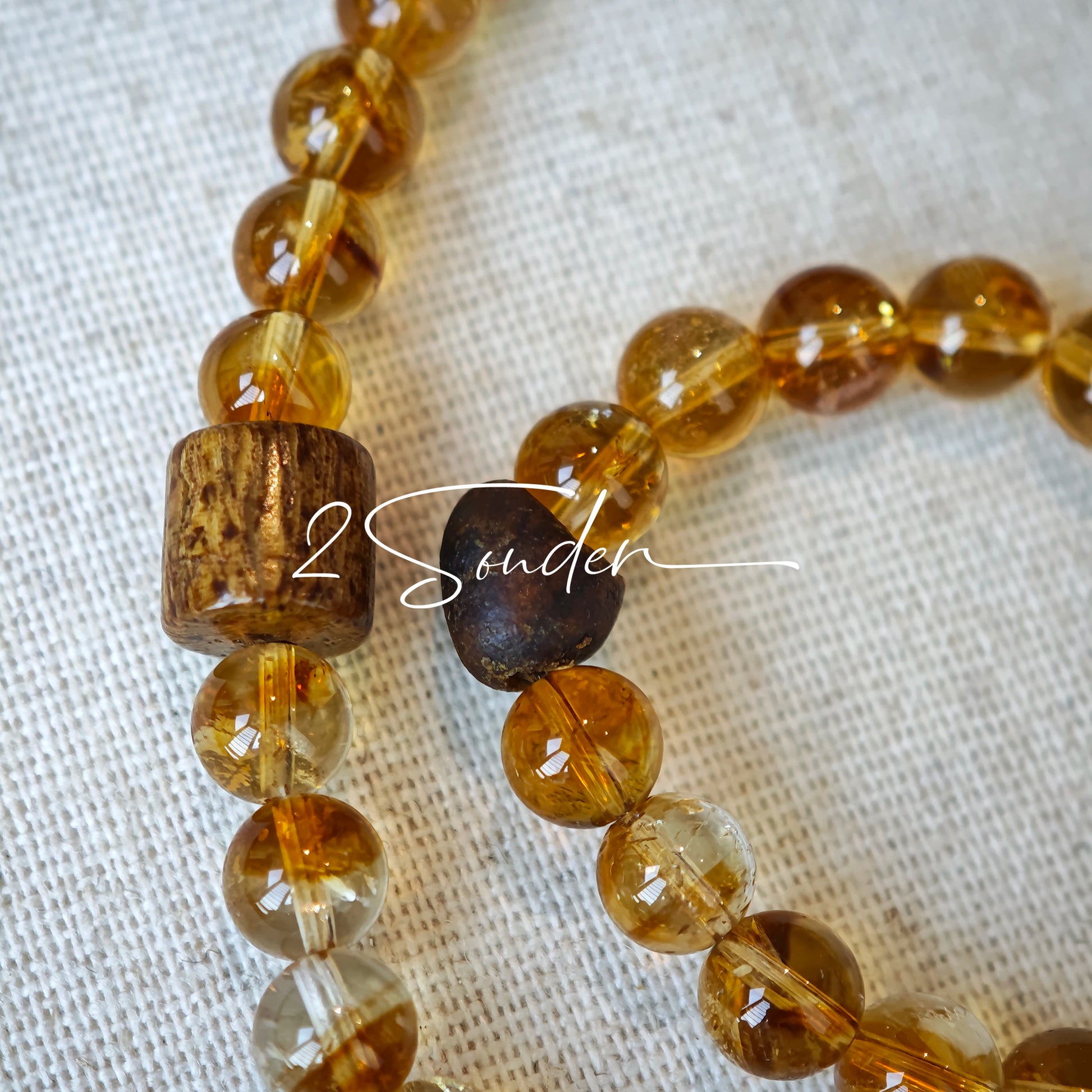 This is a layered bracelet consists of citrine beads, amethyst and aloeswood beads.
