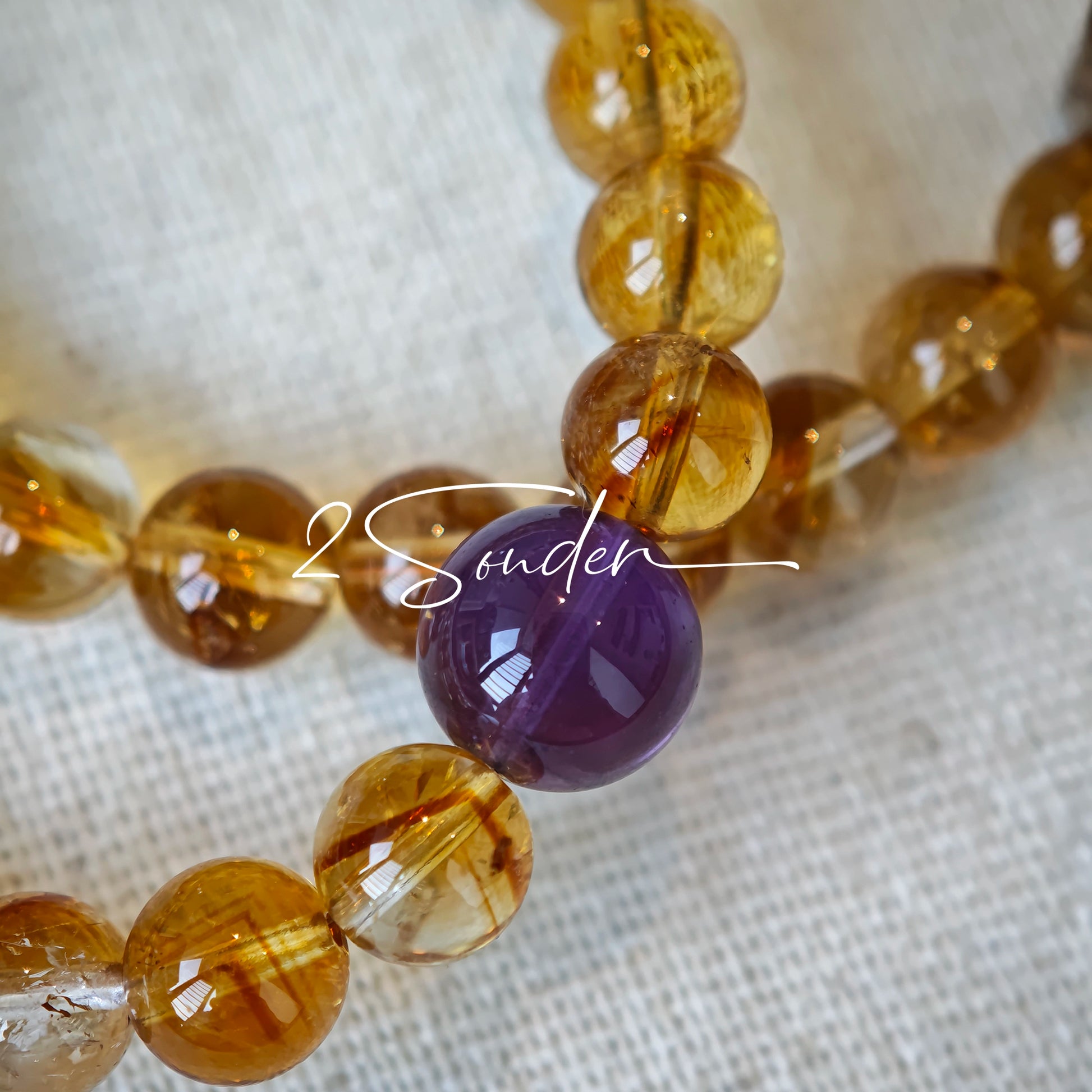 This is a layered bracelet consists of citrine beads, amethyst and aloeswood beads.