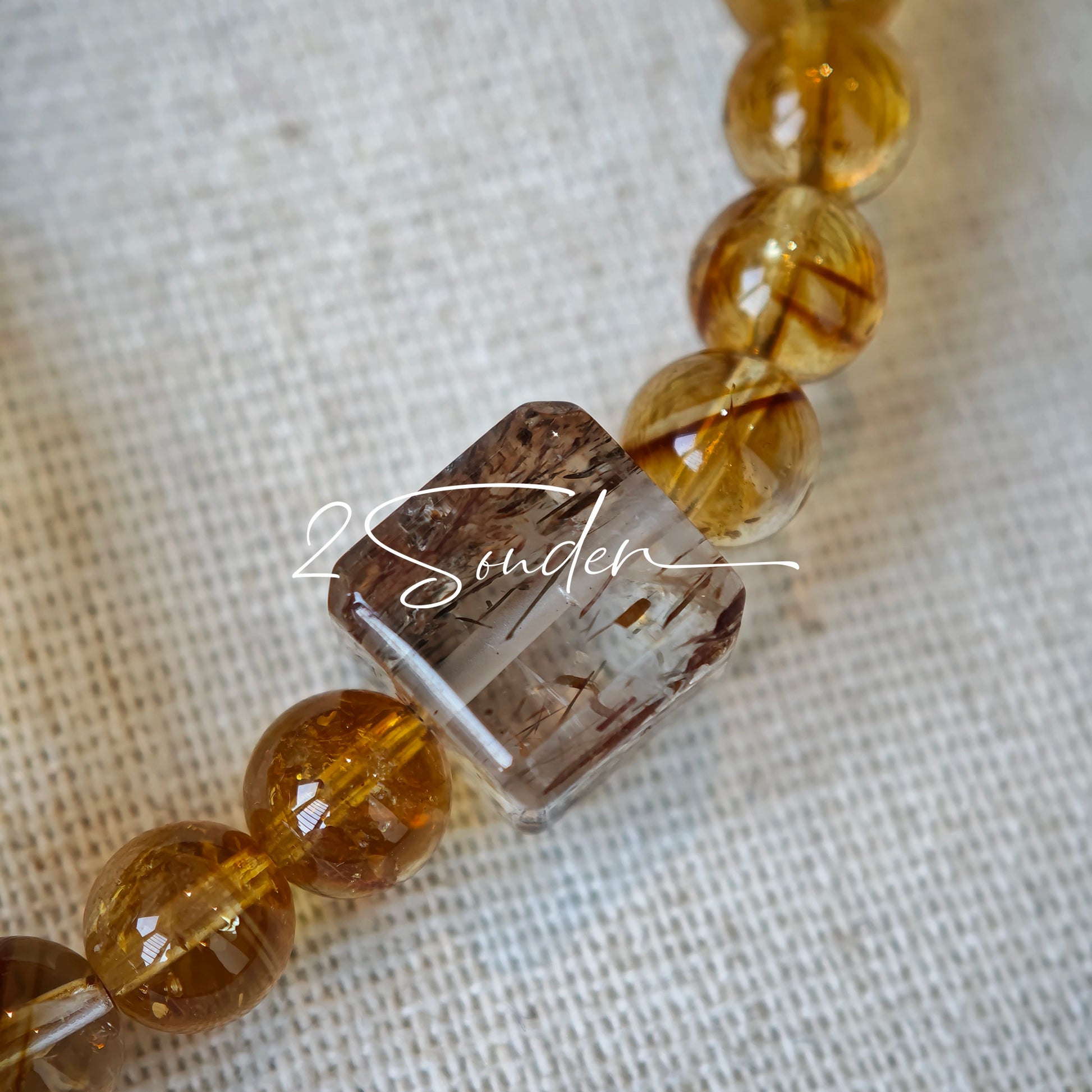 This is a layered bracelet consists of citrine beads, amethyst and aloeswood beads.