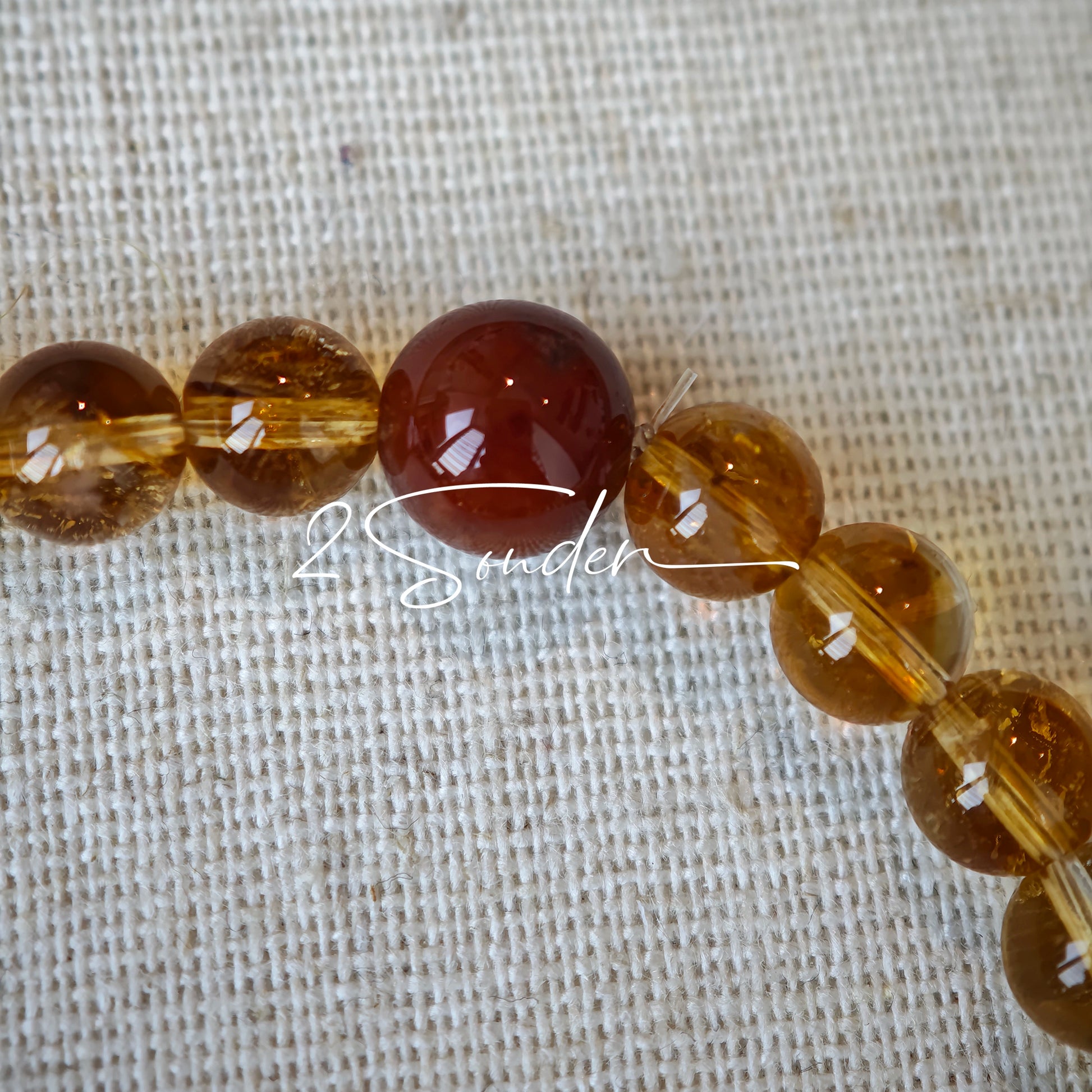 This is a layered bracelet consists of citrine beads, amethyst and aloeswood beads.