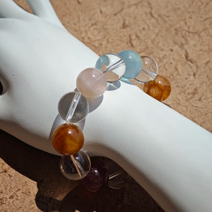 This exquisite piece features a curated blend of genuine crystals—from passionate Strawberry Quartz and tranquil Amethyst to the amplifying Clear Quartz—each selected for its unique beauty and energetic properties.