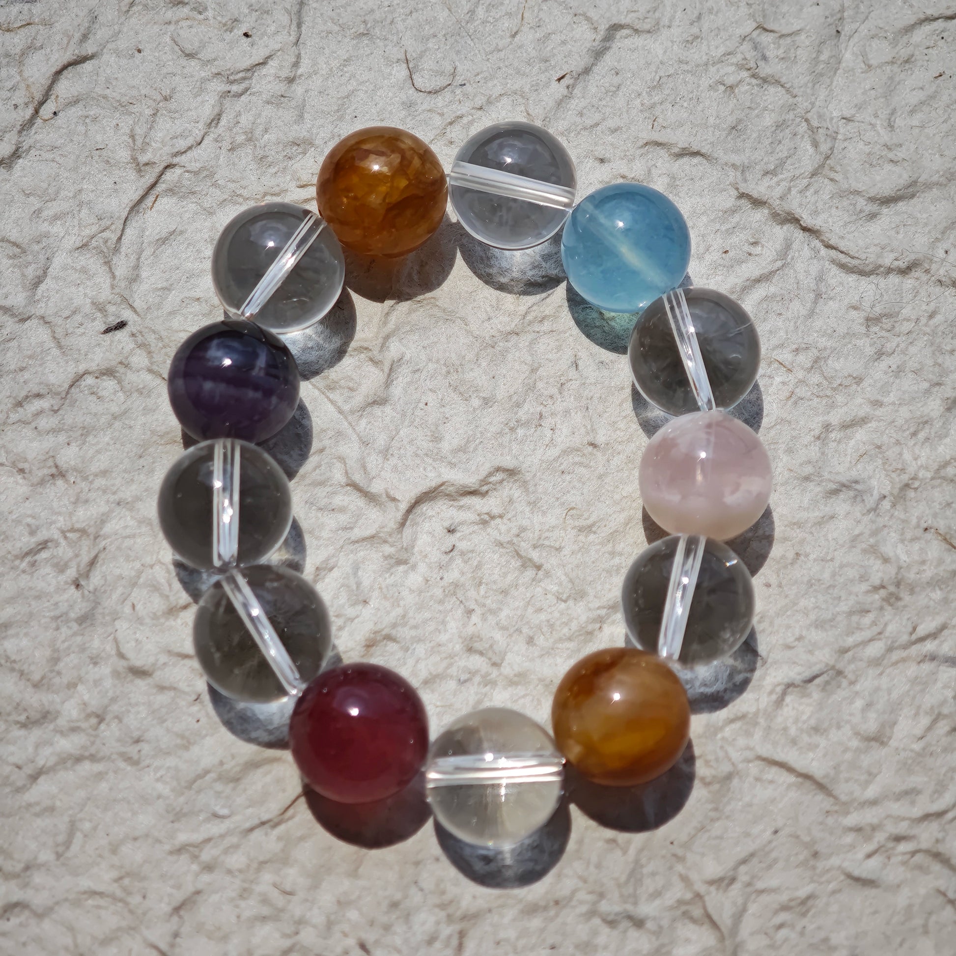 This exquisite piece features a curated blend of genuine crystals—from passionate Strawberry Quartz and tranquil Amethyst to the amplifying Clear Quartz—each selected for its unique beauty and energetic properties.