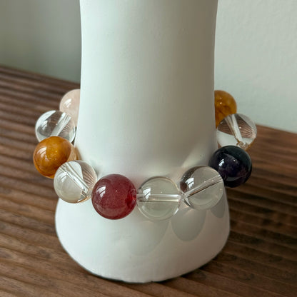 This exquisite piece features a curated blend of genuine crystals—from passionate Strawberry Quartz and tranquil Amethyst to the amplifying Clear Quartz—each selected for its unique beauty and energetic properties.