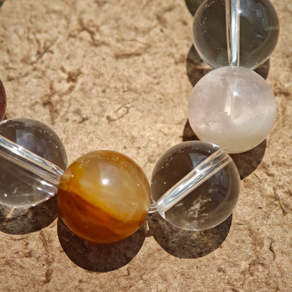 This exquisite piece features a curated blend of genuine crystals—from passionate Strawberry Quartz and tranquil Amethyst to the amplifying Clear Quartz—each selected for its unique beauty and energetic properties.