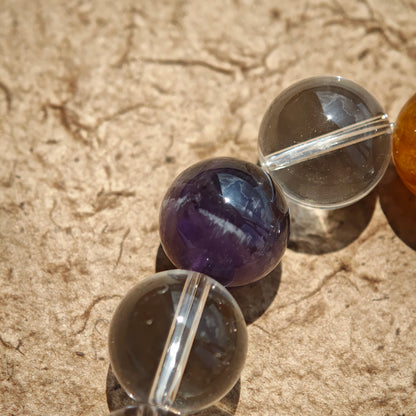 This exquisite piece features a curated blend of genuine crystals—from passionate Strawberry Quartz and tranquil Amethyst to the amplifying Clear Quartz—each selected for its unique beauty and energetic properties.