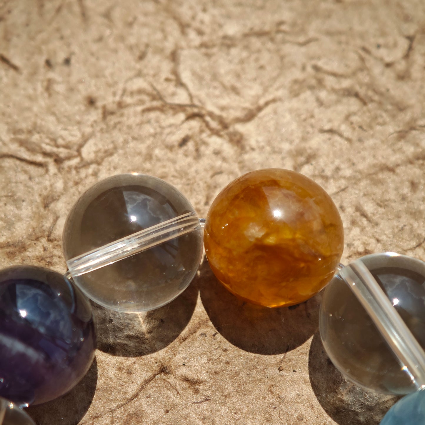 This exquisite piece features a curated blend of genuine crystals—from passionate Strawberry Quartz and tranquil Amethyst to the amplifying Clear Quartz—each selected for its unique beauty and energetic properties.