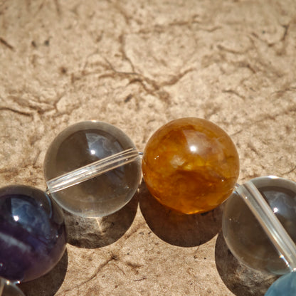 This exquisite piece features a curated blend of genuine crystals—from passionate Strawberry Quartz and tranquil Amethyst to the amplifying Clear Quartz—each selected for its unique beauty and energetic properties.