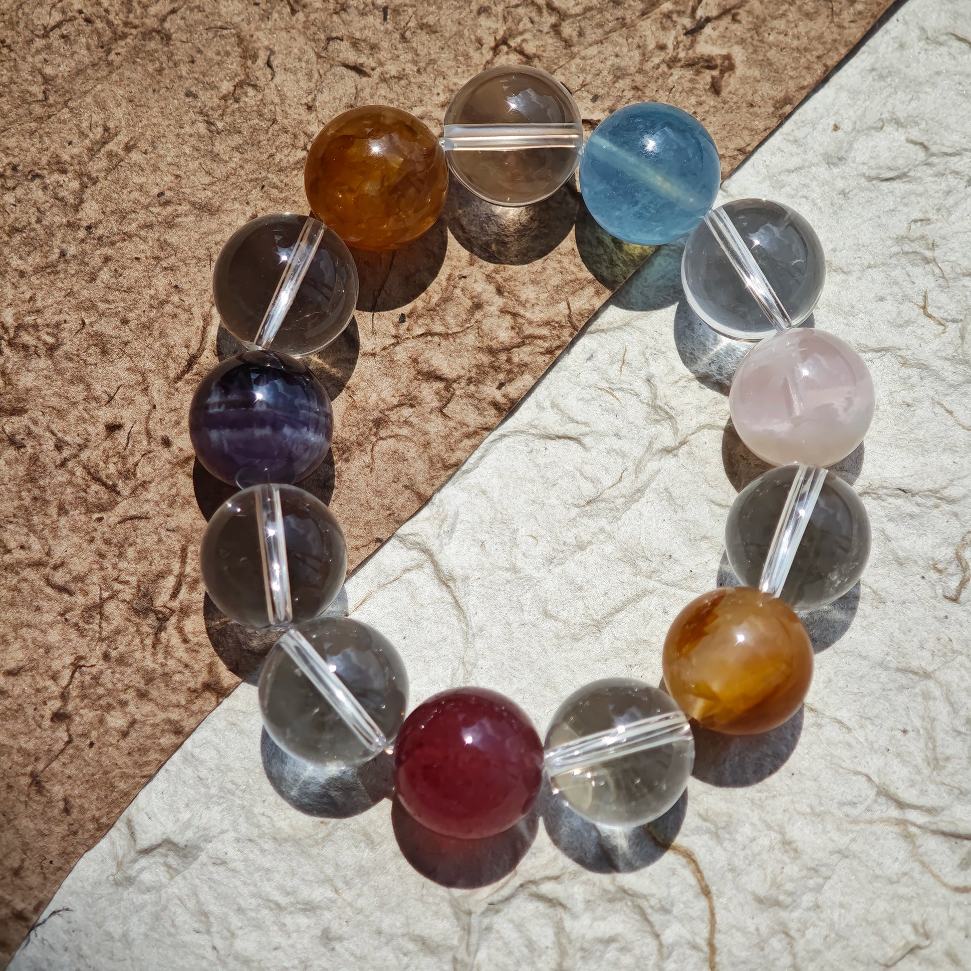 This exquisite piece features a curated blend of genuine crystals—from passionate Strawberry Quartz and tranquil Amethyst to the amplifying Clear Quartz—each selected for its unique beauty and energetic properties.