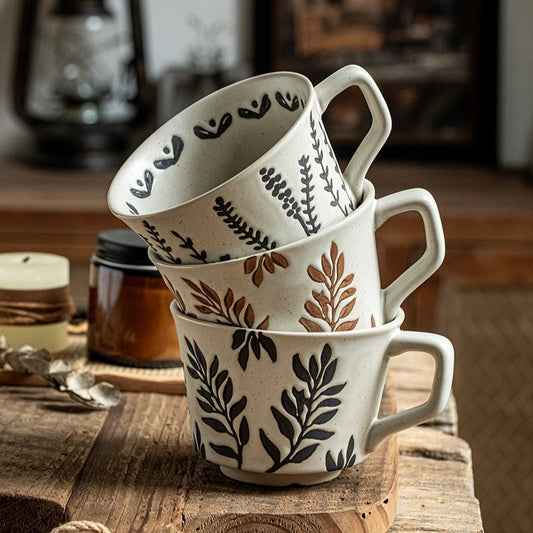 This is a 325ml coarse ceramic mug with a matte sesame-speckled glaze and hand-painted leaf design. It comes with a rounded handle that sits comfortably in your hand. Ideal for coffee, milk, water, or oatmeal during slow mornings or quiet afternoons.