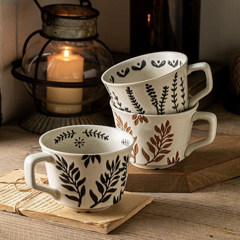 This is a 325ml coarse ceramic mug with a matte sesame-speckled glaze and hand-painted leaf design. It comes with a rounded handle that sits comfortably in your hand. Ideal for coffee, milk, water, or oatmeal during slow mornings or quiet afternoons.