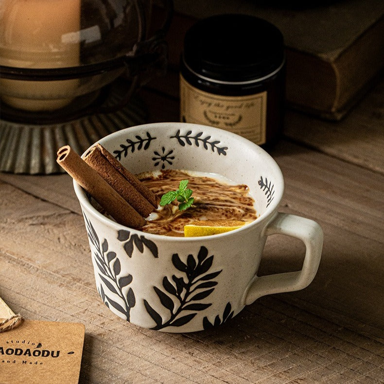 This is a 325ml coarse ceramic mug with a matte sesame-speckled glaze and hand-painted leaf design. It comes with a rounded handle that sits comfortably in your hand. Ideal for coffee, milk, water, or oatmeal during slow mornings or quiet afternoons.