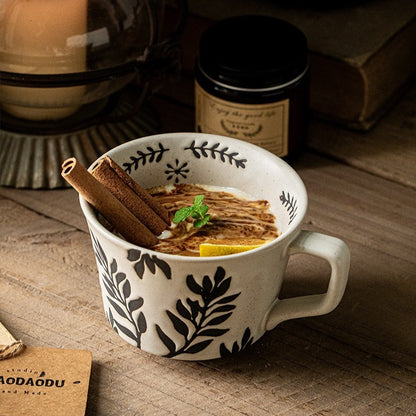 This is a 325ml coarse ceramic mug with a matte sesame-speckled glaze and hand-painted leaf design. It comes with a rounded handle that sits comfortably in your hand. Ideal for coffee, milk, water, or oatmeal during slow mornings or quiet afternoons.