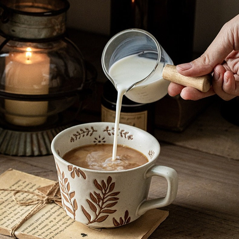 This is a 325ml coarse ceramic mug with a matte sesame-speckled glaze and hand-painted leaf design. It comes with a rounded handle that sits comfortably in your hand. Ideal for coffee, milk, water, or oatmeal during slow mornings or quiet afternoons.
