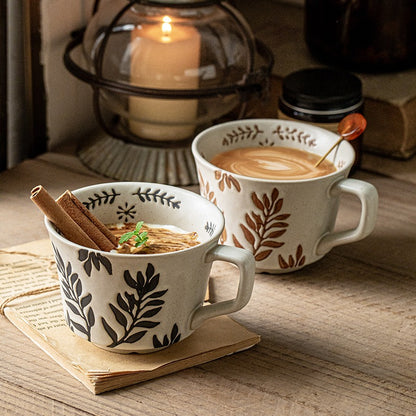 This is a 325ml coarse ceramic mug with a matte sesame-speckled glaze and hand-painted leaf design. It comes with a rounded handle that sits comfortably in your hand. Ideal for coffee, milk, water, or oatmeal during slow mornings or quiet afternoons.