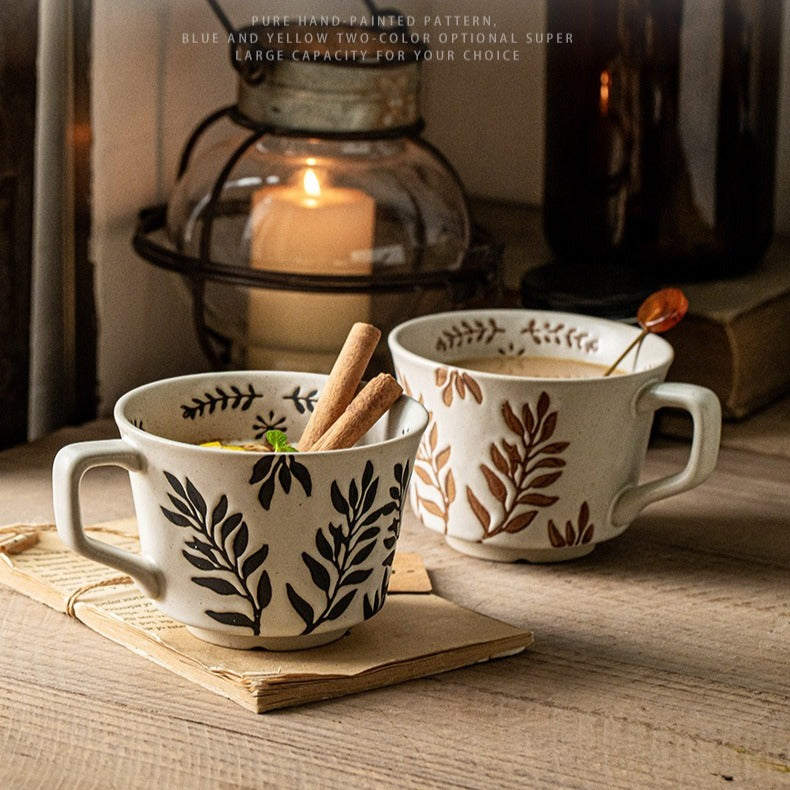 This is a 325ml coarse ceramic mug with a matte sesame-speckled glaze and hand-painted leaf design. It comes with a rounded handle that sits comfortably in your hand. Ideal for coffee, milk, water, or oatmeal during slow mornings or quiet afternoons.