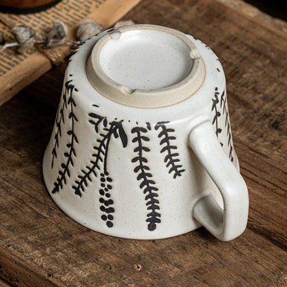 This is a 325ml coarse ceramic mug with a matte sesame-speckled glaze and hand-painted leaf design. It comes with a rounded handle that sits comfortably in your hand. Ideal for coffee, milk, water, or oatmeal during slow mornings or quiet afternoons.