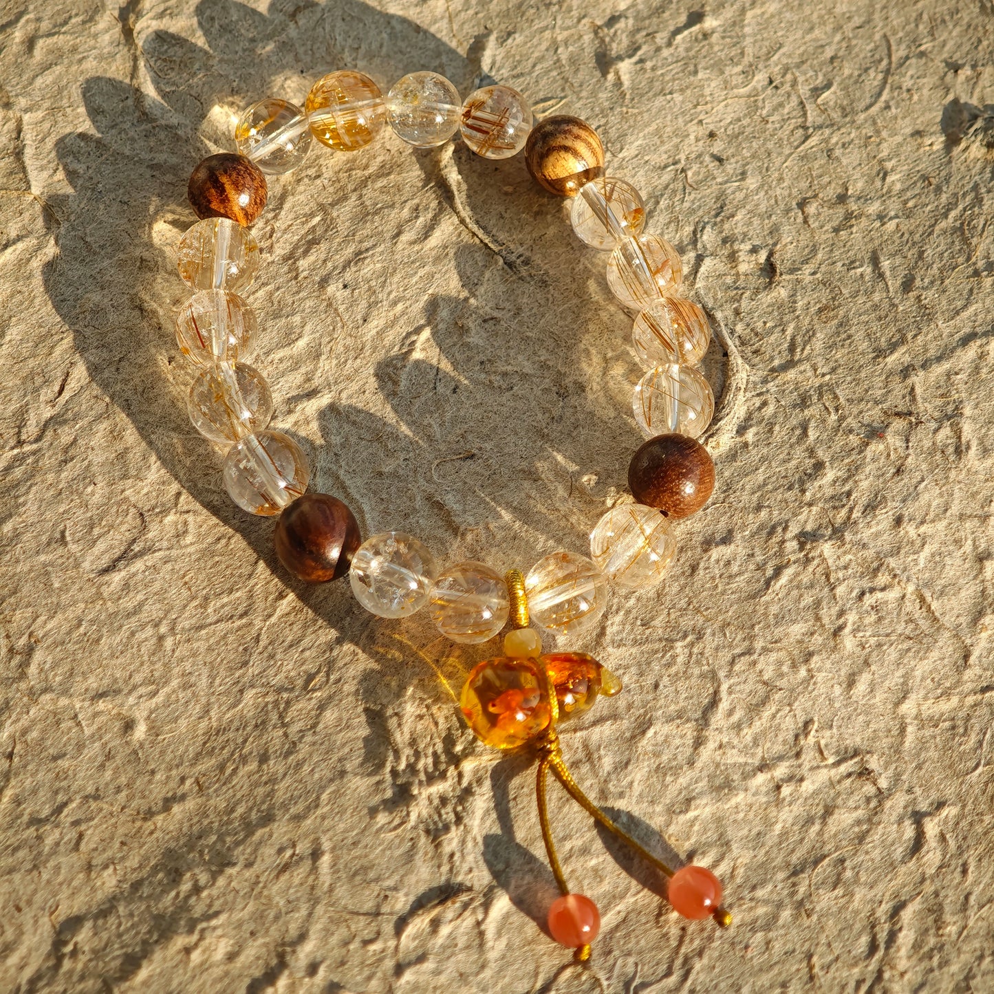 Sparkling rutile quartz and mellow agarwood unite, their union blessed by a Nanhong-carved flower gourd of protection.
