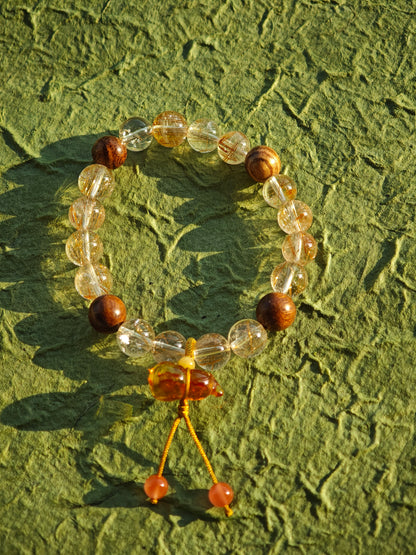Fire-kissed crystals dance with fragrant wood, while a flower-shaped amber calabash offers ancient promise: thrive and be shielded.