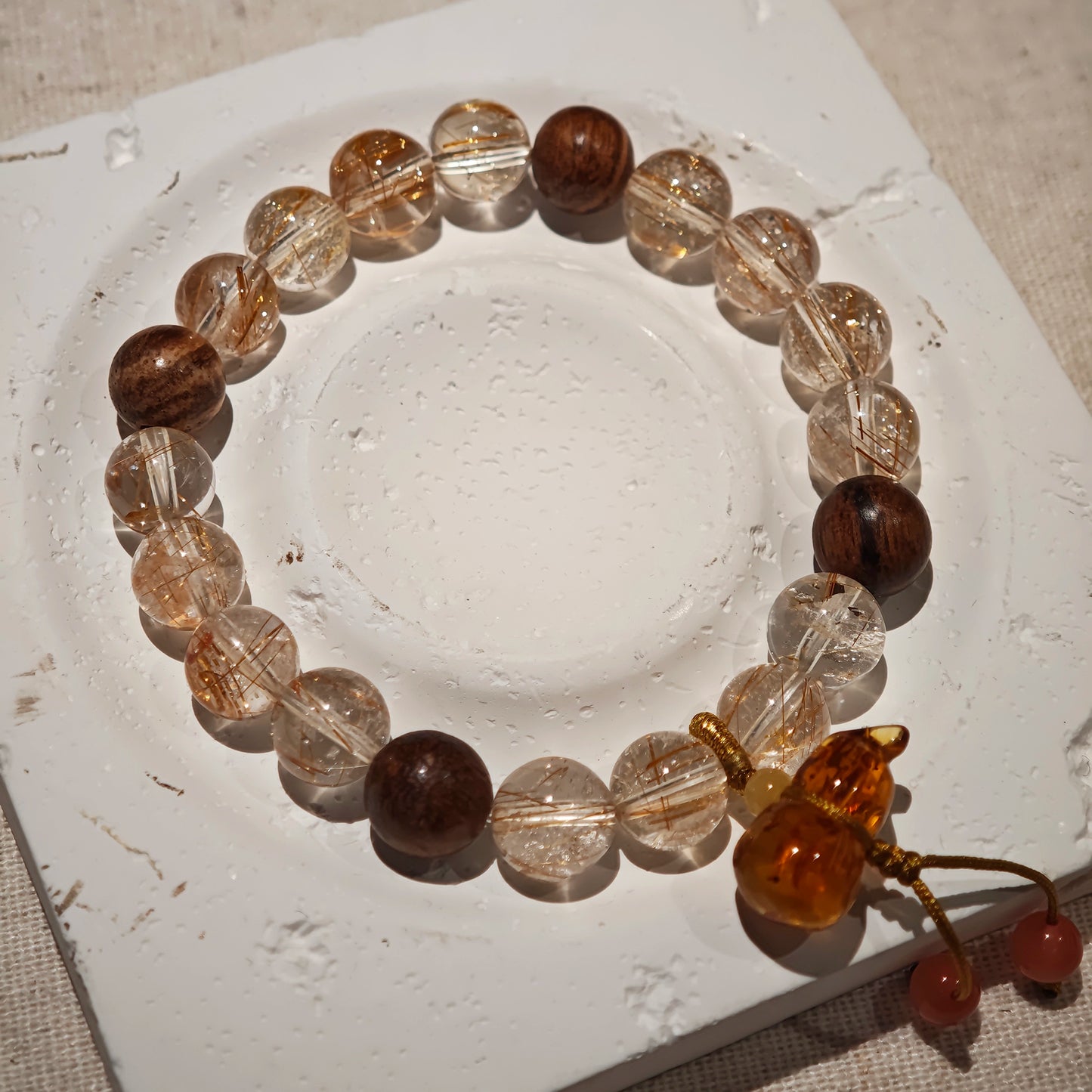 Power and perfume circle the wrist, finishing in a bloom-shaped calabash: prosper wildly, sleep safely.