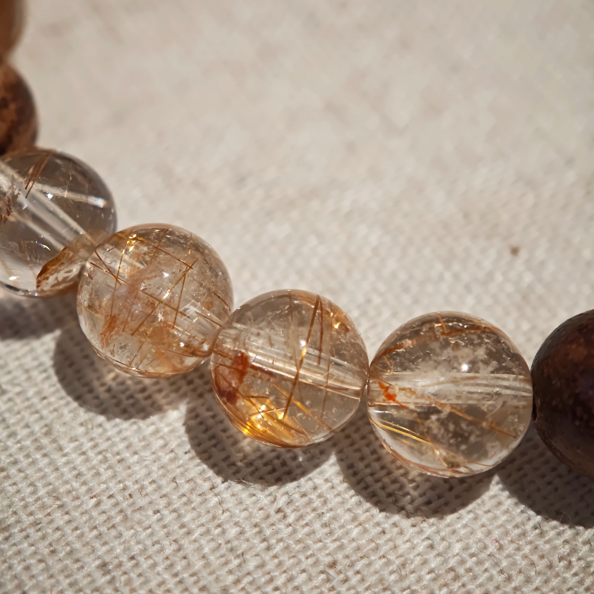 Copper needles sparkle inside each quartz bead, agarwood exhales calm, and the Nanhong gourd seals luck and safety in bloom.
