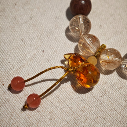 Copper sunbursts swirl through quartz, agarwood beads steady the soul, and the Nanhong calabash curls around fortune and defense.