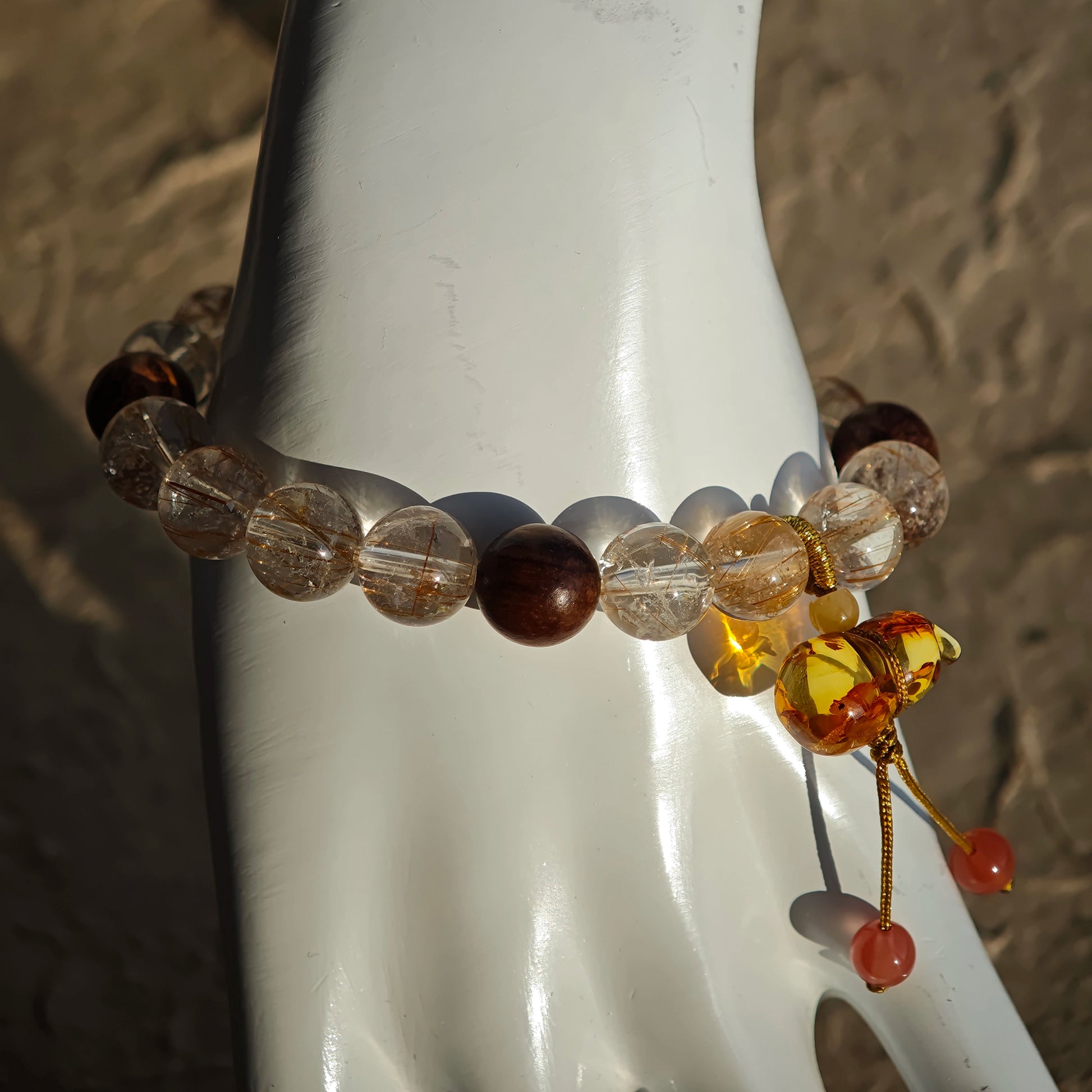 Golden needles pierce the dark, woody scent calms the heart, and a flower-amber gourd promises safe abundance.