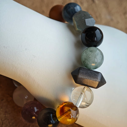 Silver flashes, purple hues and pale gold unite in this cool-tone rutile-phantom-citrine-amethyst-moonstone-obsidian strand.