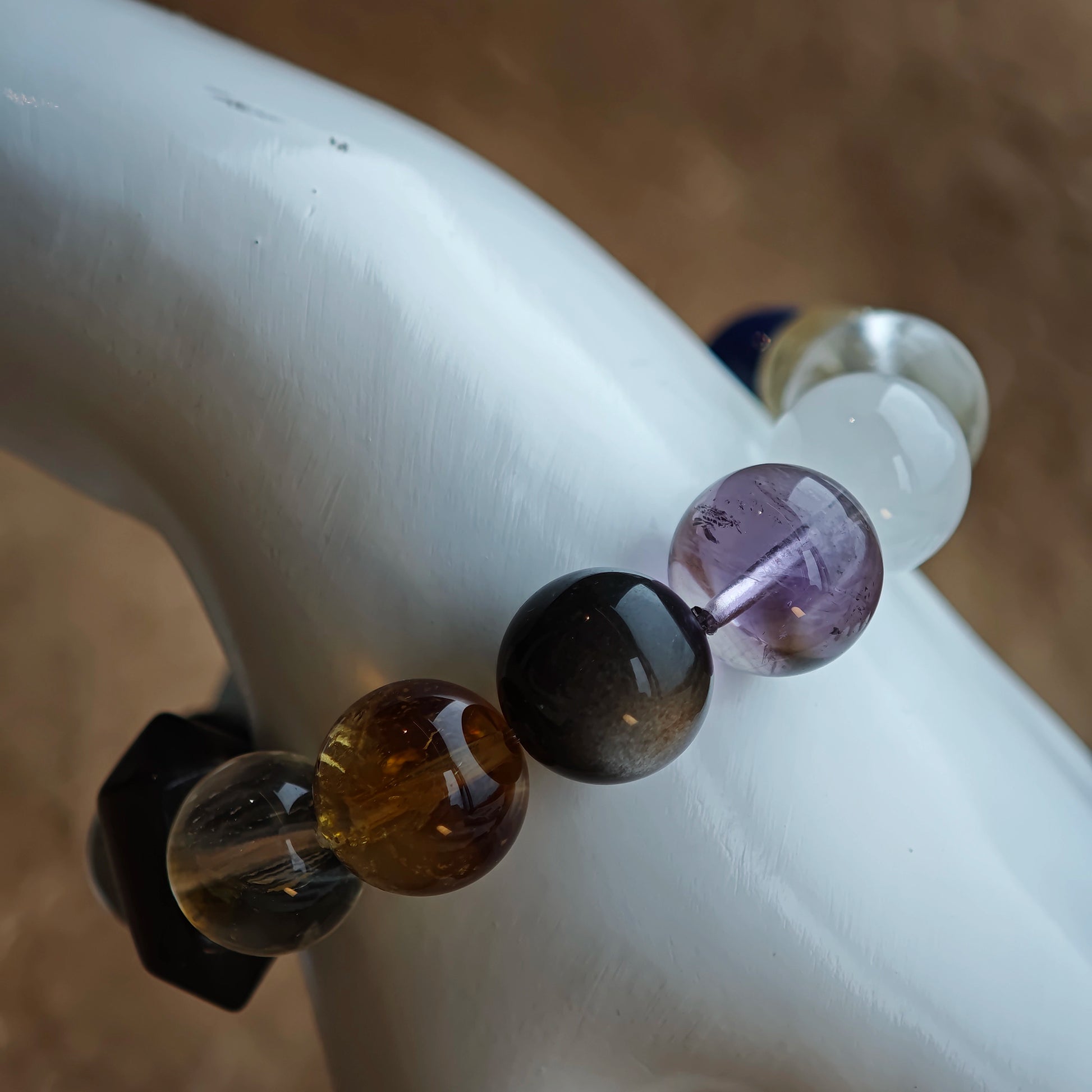 Cool blues, purples and silvers mingle thanks to rutile, phantom, citrine, amethyst, moonstone and silver-sheen obsidian.