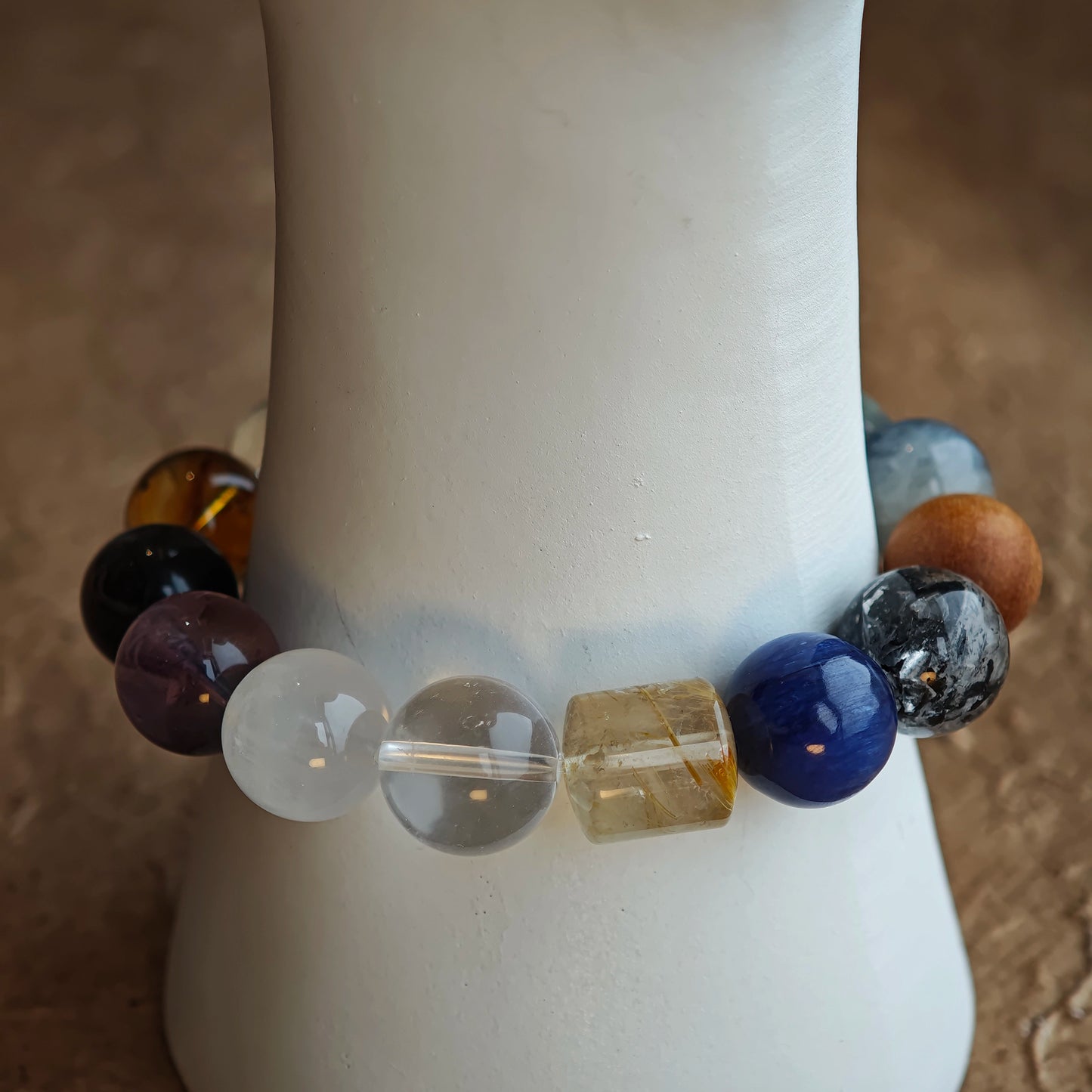 From rutile’s golden threads to moonstone’s blue glow, the bracelet stays cool and enigmatic.