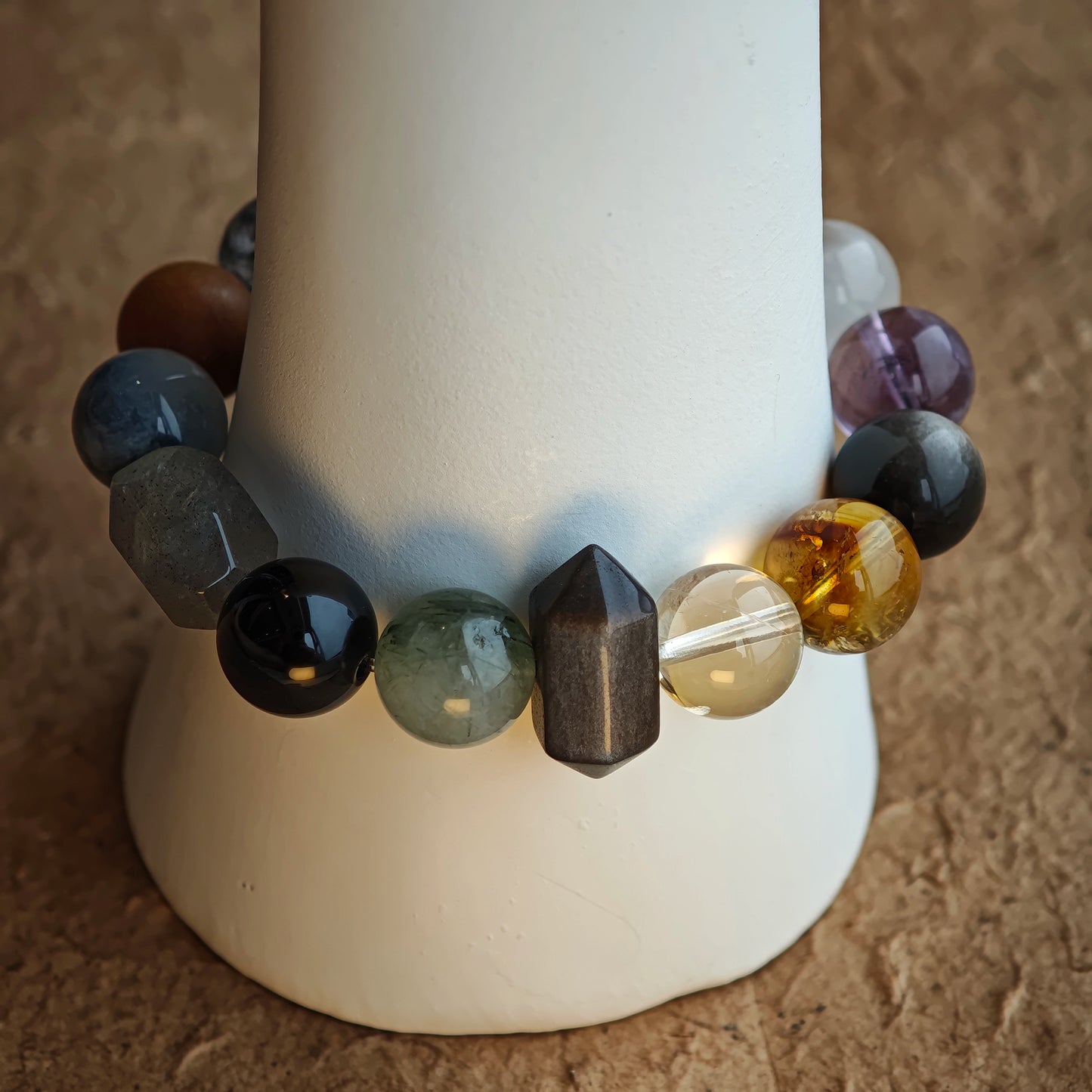 This crystal chain keeps it sleek—rutile, phantom, citrine, amethyst, moonstone, obsidian—all in soft, cold shades.