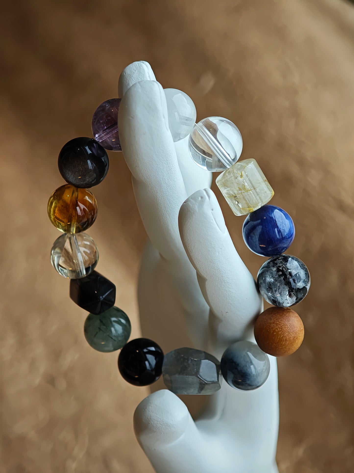 One neutral-friendly strand: rutilated quartz, white phantom, citrine, amethyst, moonstone and silver obsidian—mystery made simple.