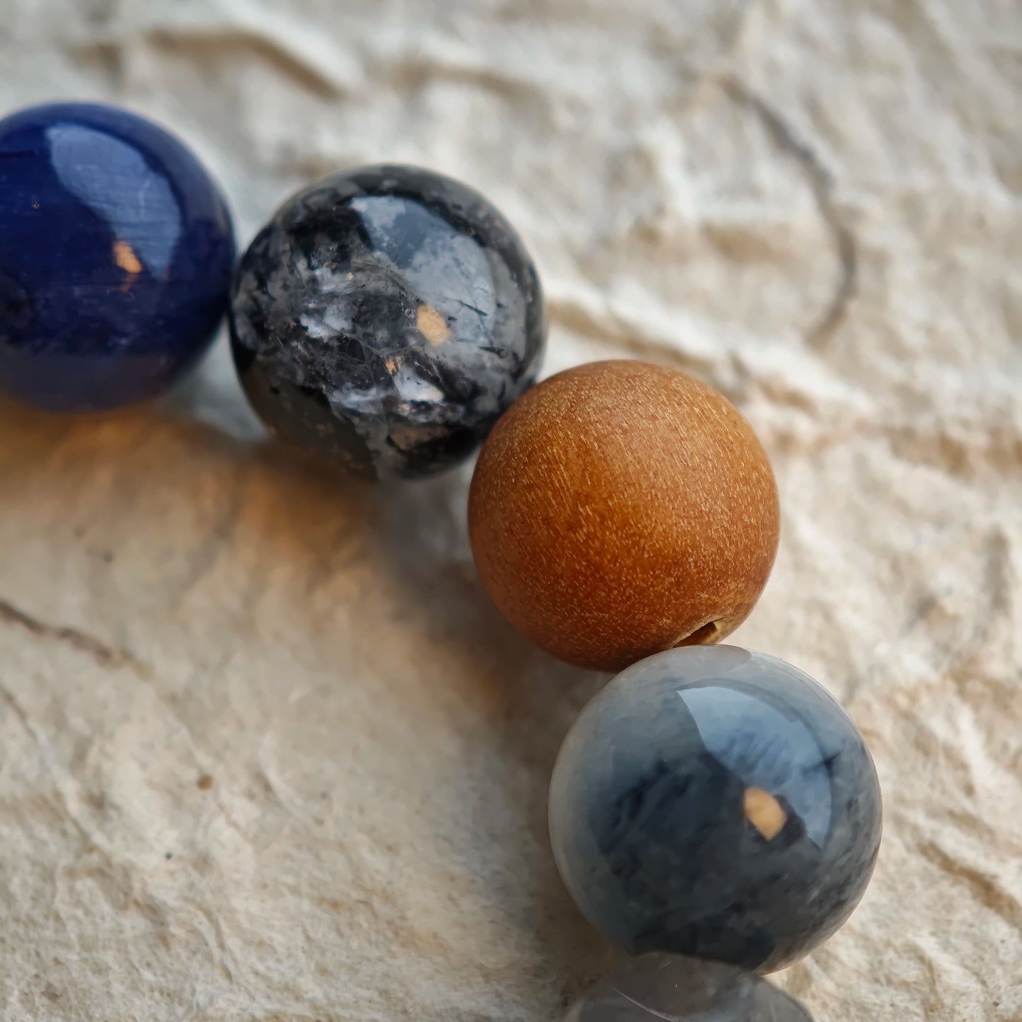 Let rutilated quartz, white phantom, citrine, amethyst, moonstone and silver obsidian tint your wrist in frosty elegance.